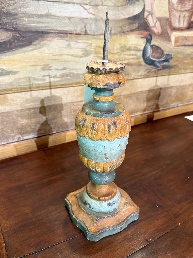 Italian candle holder with patina finish on a wooden surface