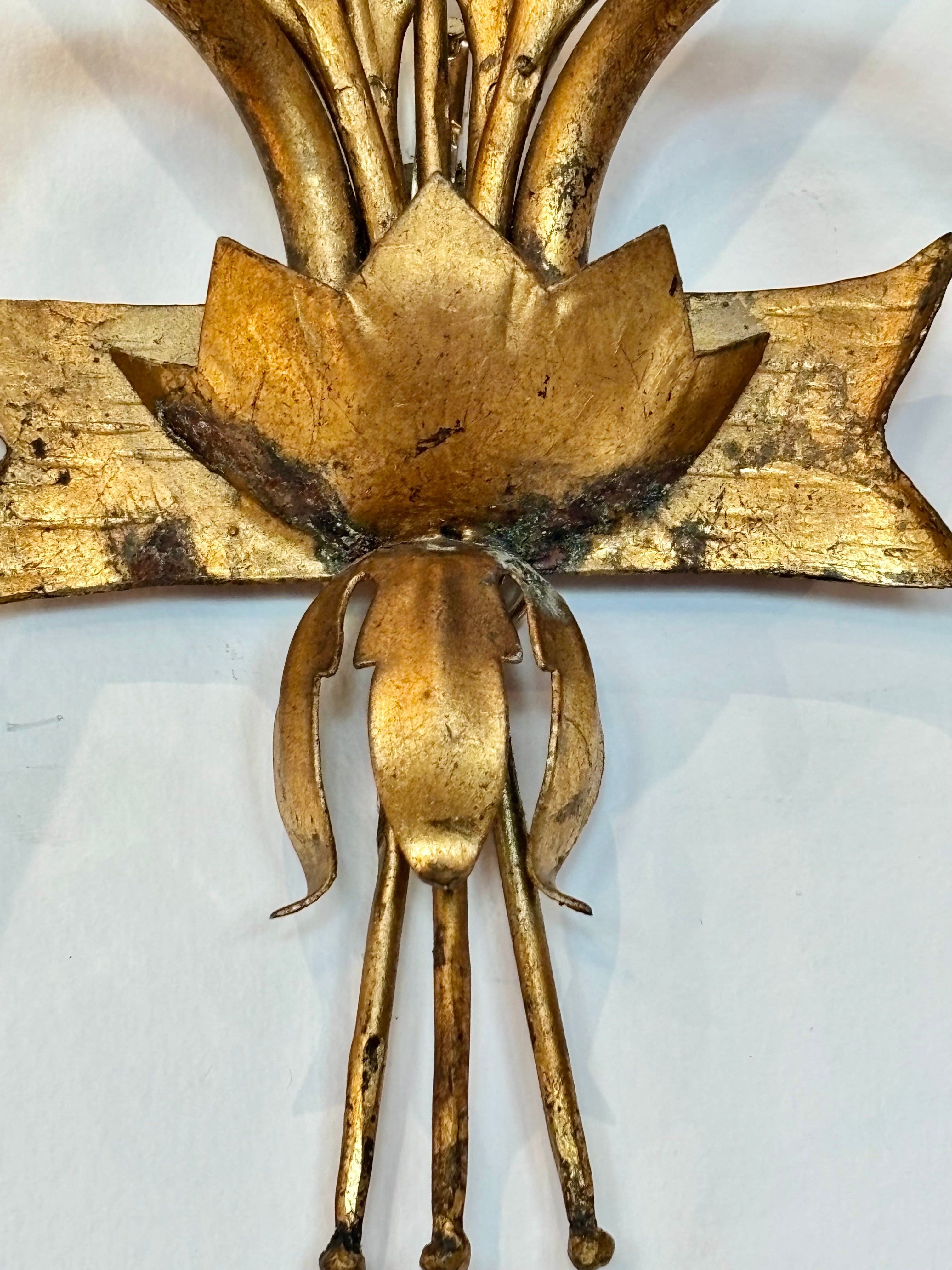 Gold decorative wall sconce on a white background