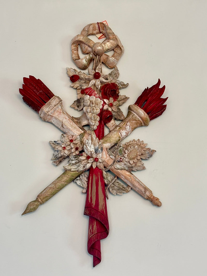 Decorative sconces with red and gold elements on a light gray background