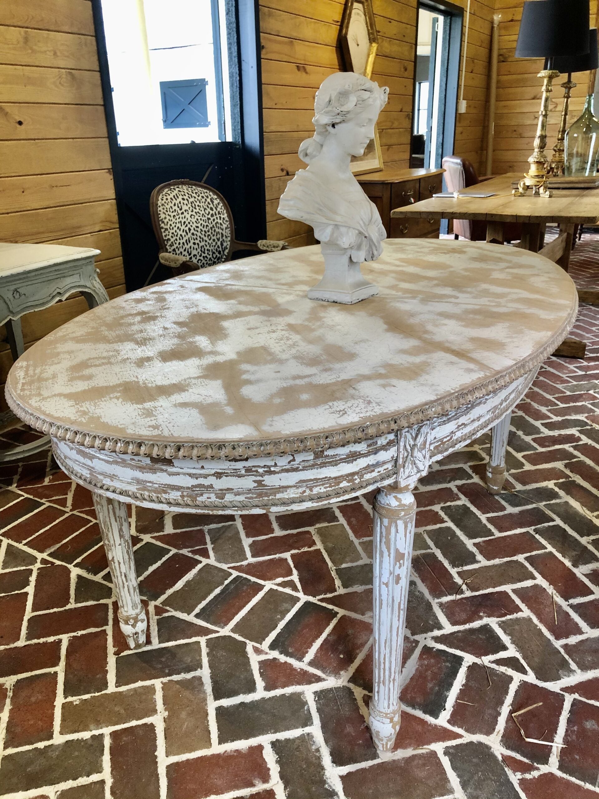 Small whitewashed dining table with fluted legs