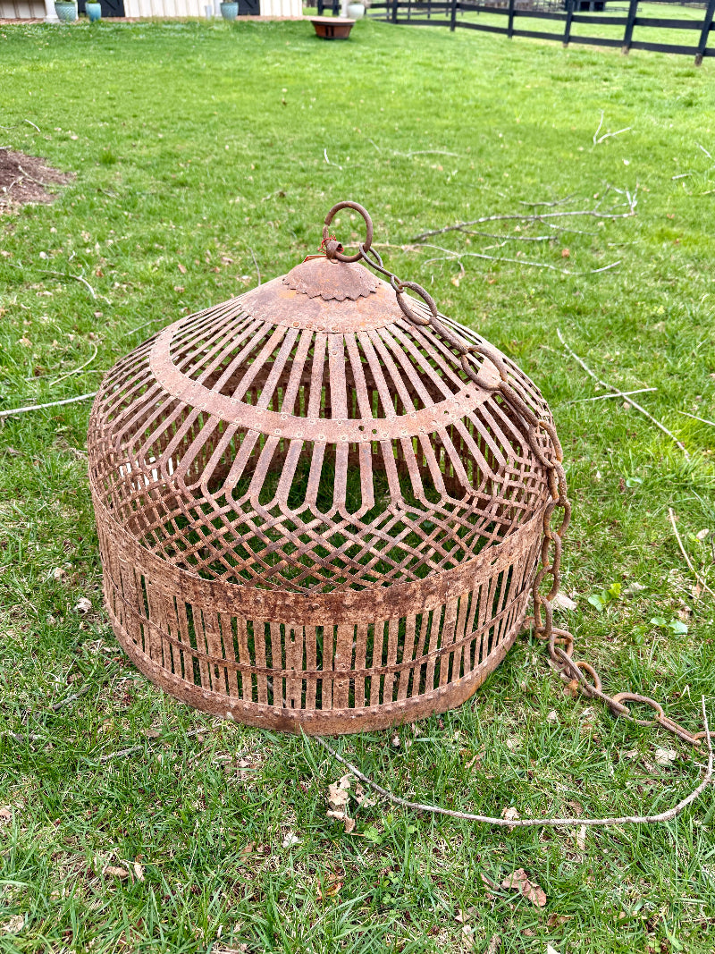 Rustic birdcage lantern on a grassy field