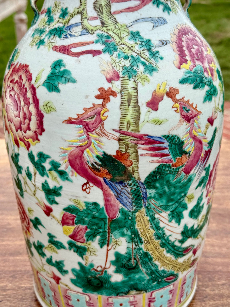 Colorful ceramic vase with intricate dragon and floral design on a wooden surface.