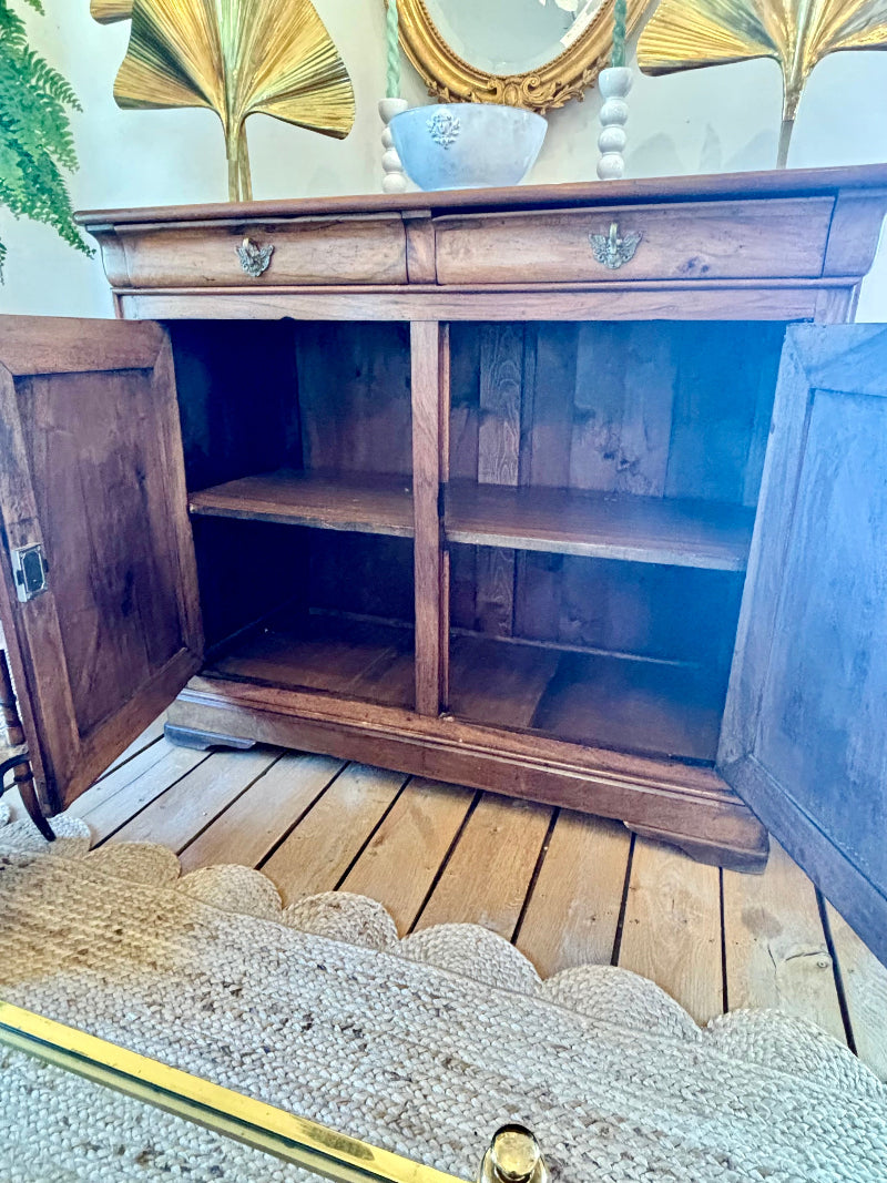 Wooden cabinet with open doors on a wooden floor