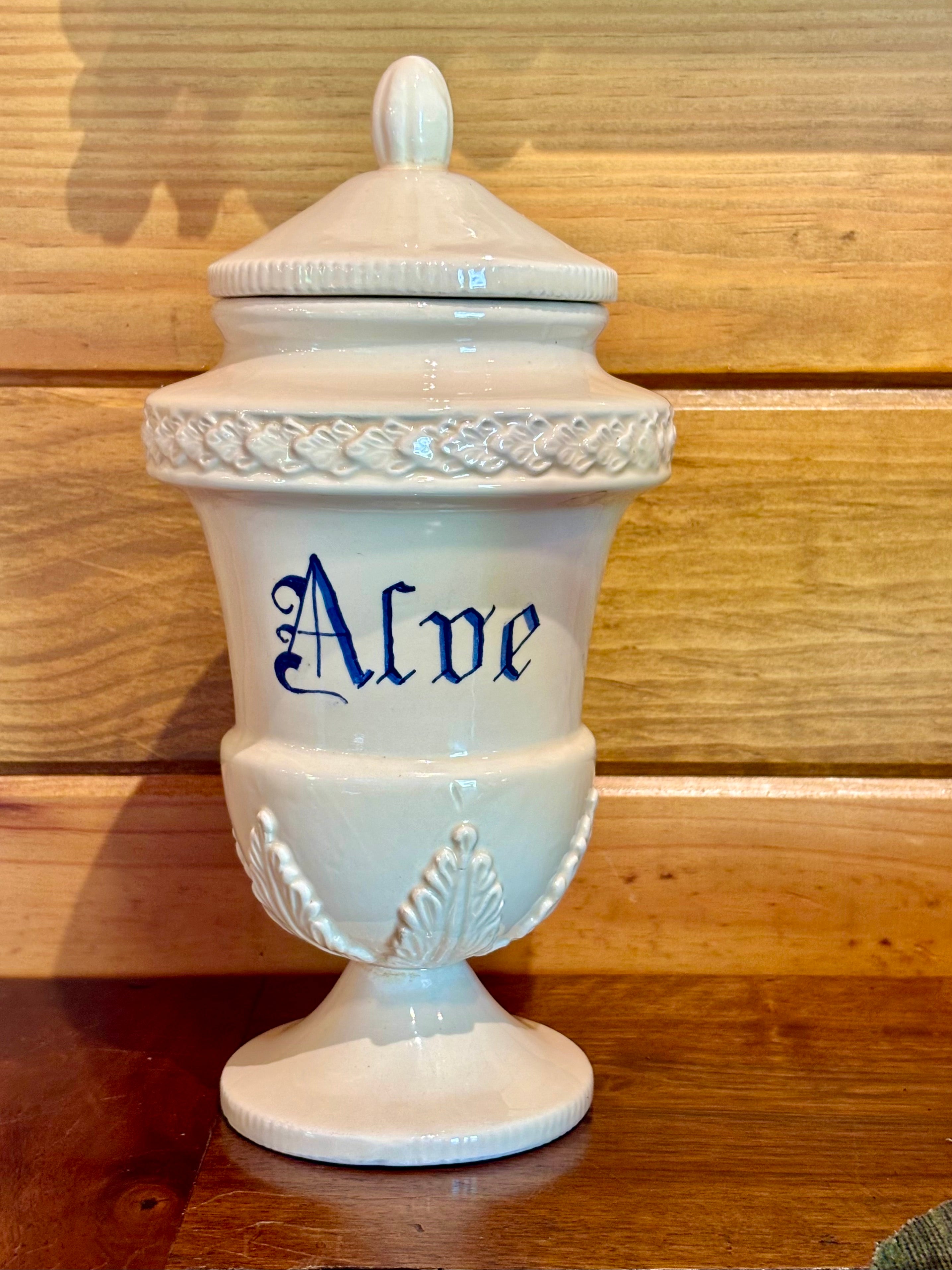 Antique Apothecary jar with 'Alve' inscription on a wooden surface
