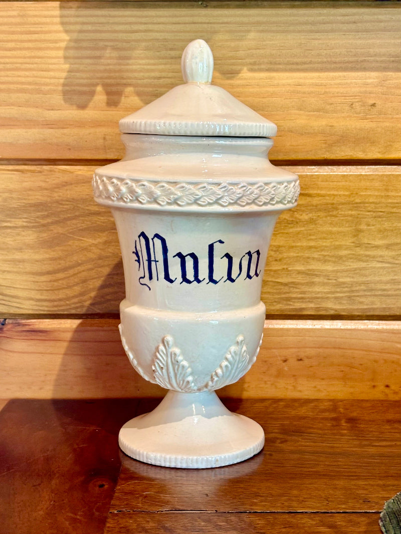 White CERAMIC APOTHECARY JAR with 'Malva' inscription on a wooden surface