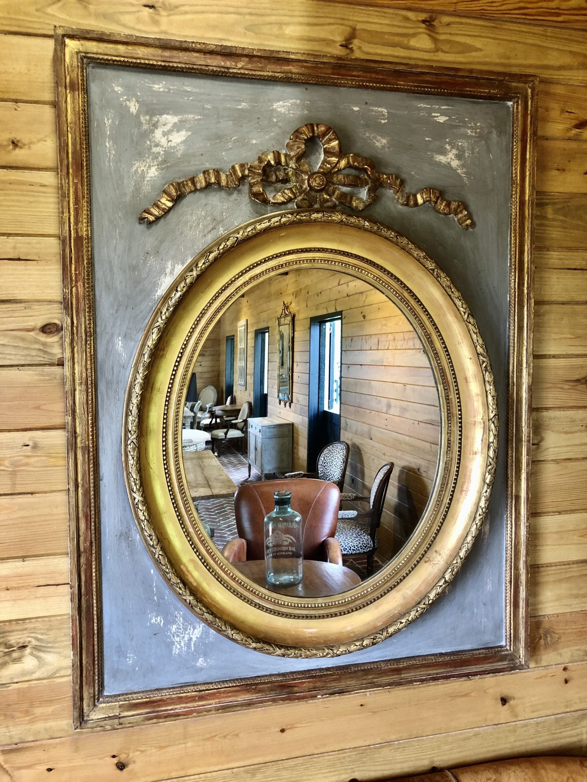 Gilded oval mirror in rectangular frame
