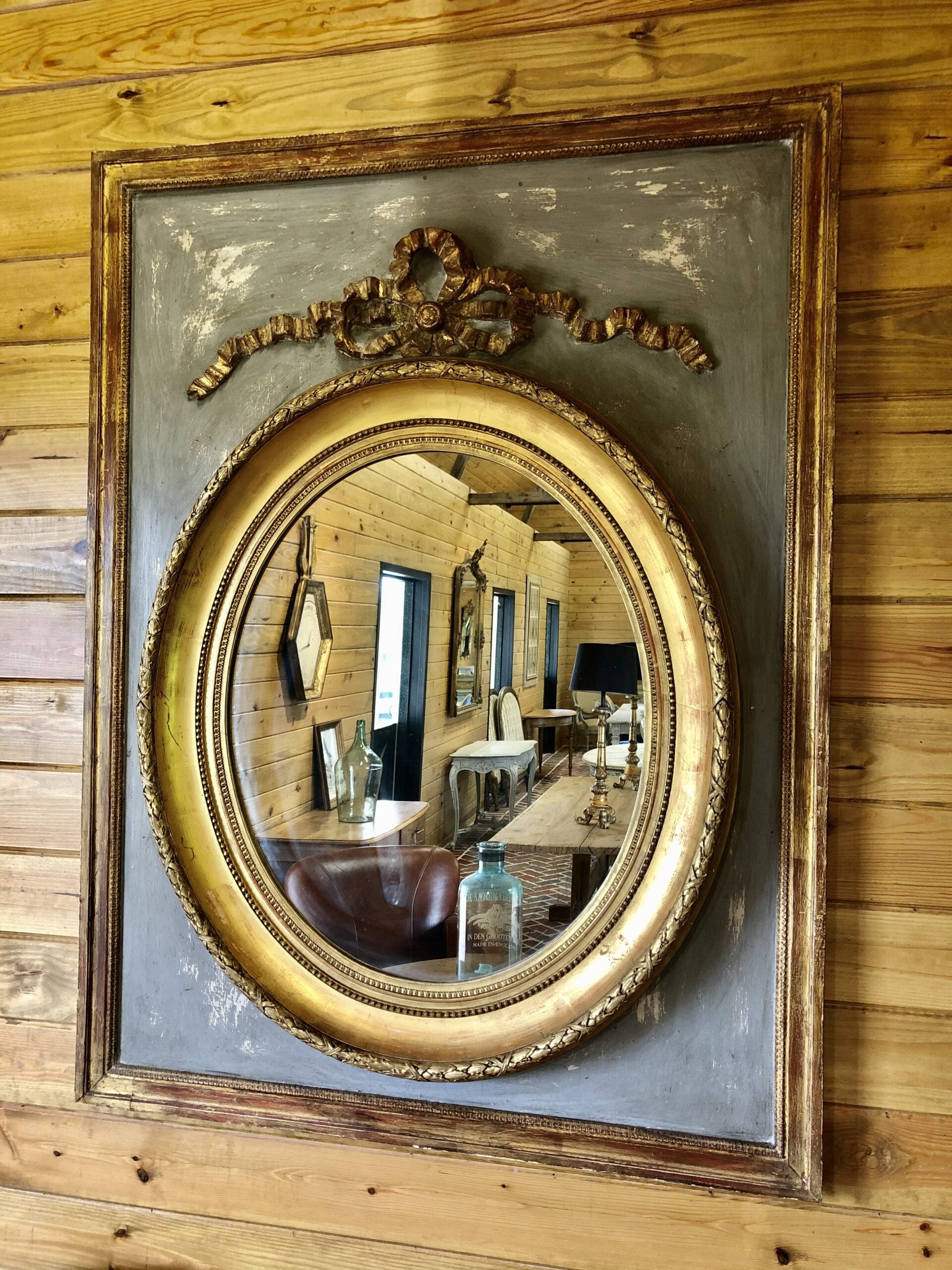 Gilded oval mirror in rectangular frame2